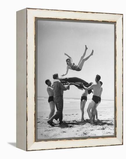 Army Men Bouncing Starlet Majorie Woodworth Into the Air-John Florea-Framed Premier Image Canvas