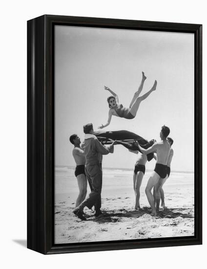 Army Men Bouncing Starlet Majorie Woodworth Into the Air-John Florea-Framed Premier Image Canvas