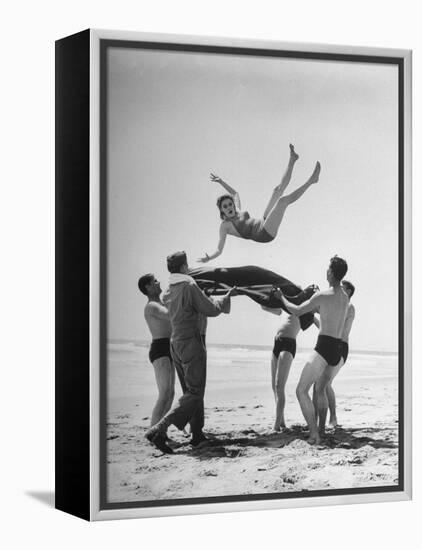 Army Men Bouncing Starlet Majorie Woodworth Into the Air-John Florea-Framed Premier Image Canvas