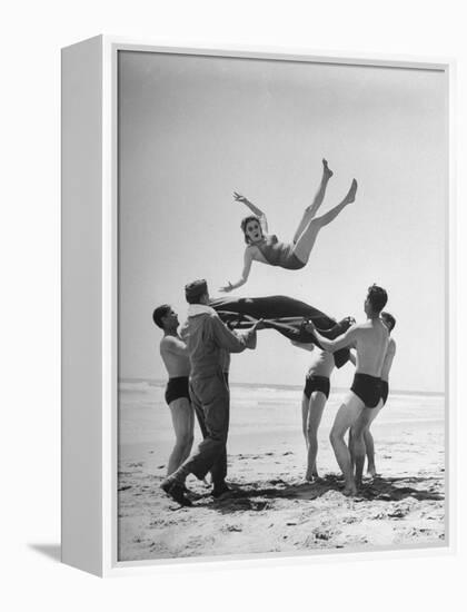 Army Men Bouncing Starlet Majorie Woodworth Into the Air-John Florea-Framed Premier Image Canvas