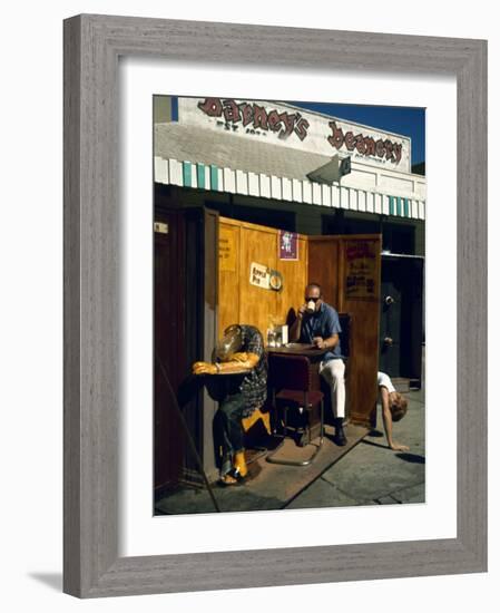 Artist Ed Kienholz Drinking Coffee Inside Section of His Assemblage "The Beanery. "-Ralph Crane-Framed Photographic Print