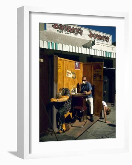 Artist Ed Kienholz Drinking Coffee Inside Section of His Assemblage "The Beanery. "-Ralph Crane-Framed Photographic Print