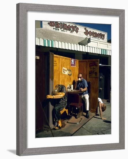 Artist Ed Kienholz Drinking Coffee Inside Section of His Assemblage "The Beanery. "-Ralph Crane-Framed Photographic Print