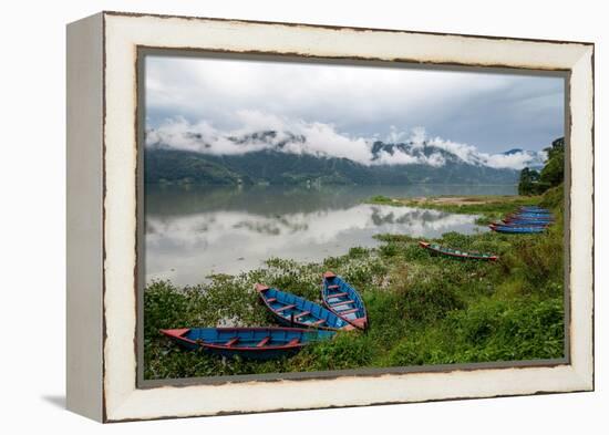 Asia, Nepal, Pokhara. Boats in the water lilies on Phewa Lake.-Janell Davidson-Framed Premier Image Canvas