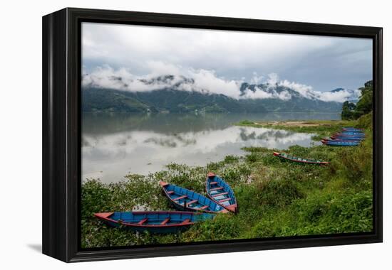 Asia, Nepal, Pokhara. Boats in the water lilies on Phewa Lake.-Janell Davidson-Framed Premier Image Canvas