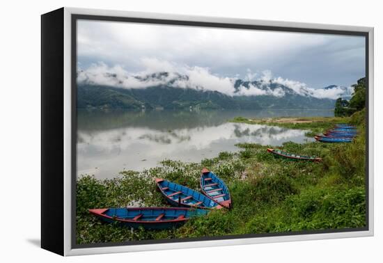 Asia, Nepal, Pokhara. Boats in the water lilies on Phewa Lake.-Janell Davidson-Framed Premier Image Canvas