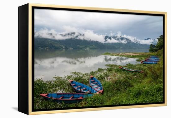 Asia, Nepal, Pokhara. Boats in the water lilies on Phewa Lake.-Janell Davidson-Framed Premier Image Canvas