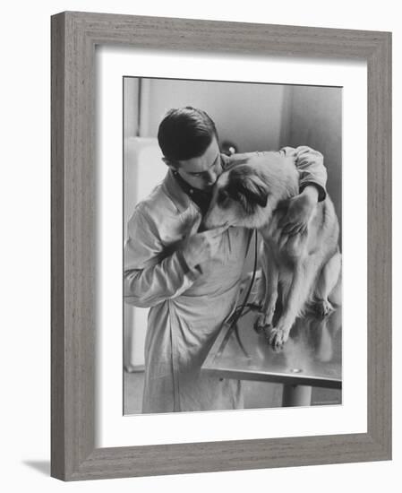 Assistant Caring For a Dog at the Humane Society-Paul Schutzer-Framed Photographic Print