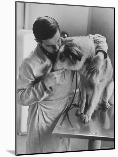 Assistant Caring For a Dog at the Humane Society-Paul Schutzer-Mounted Photographic Print