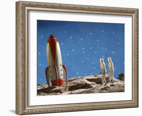 Astronaut Figurines Standing Beside Toy Rocket-null-Framed Photographic Print
