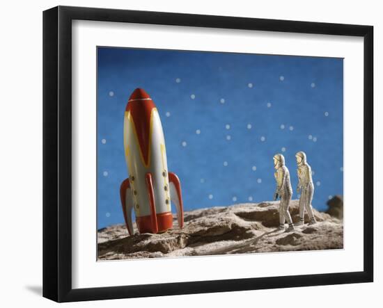 Astronaut Figurines Standing Beside Toy Rocket-null-Framed Photographic Print