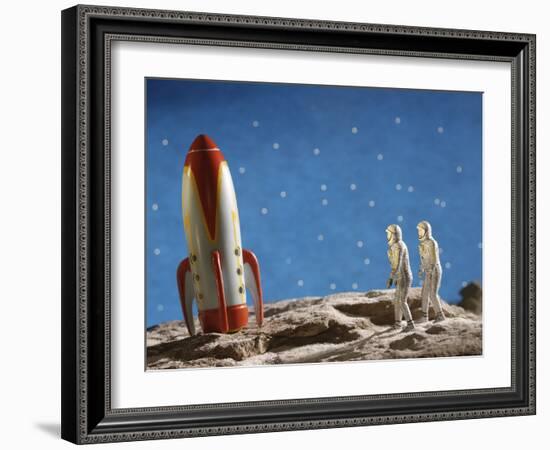 Astronaut Figurines Standing Beside Toy Rocket-null-Framed Photographic Print