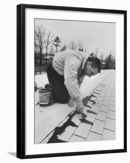 Astronaut Virgil I. Grissom Using Roof Cement at Home-Ralph Morse-Framed Premium Photographic Print
