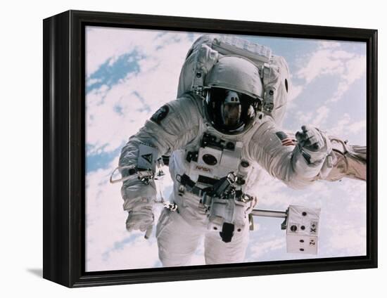 Astronaut Walking in Space-David Bases-Framed Premier Image Canvas