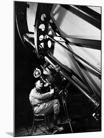 Astronomer Edwin Powell Hubble Looking Though Eyepiece of Telescope at Mt. Wilson Observatory-Margaret Bourke-White-Mounted Premium Photographic Print