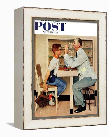 "At the Optometrist" or "Eye Doctor" Saturday Evening Post Cover, May 19,1956-Norman Rockwell-Framed Premier Image Canvas