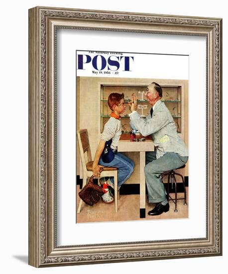 "At the Optometrist" or "Eye Doctor" Saturday Evening Post Cover, May 19,1956-Norman Rockwell-Framed Giclee Print