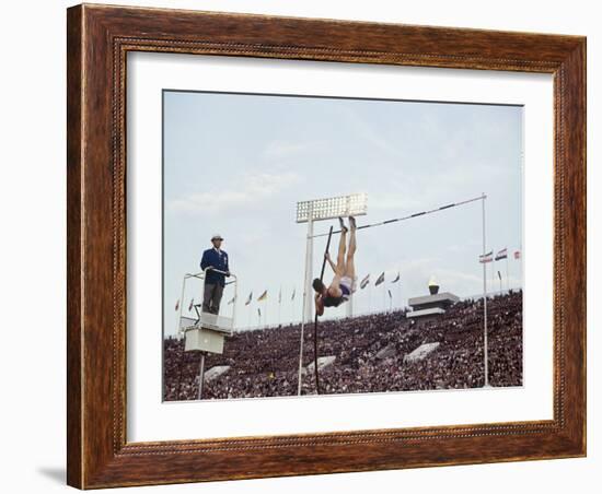 Athlete Clearing the Pole Vault at Summer Olympics-John Dominis-Framed Photographic Print