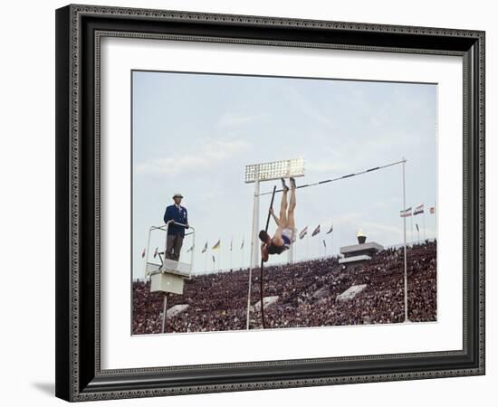 Athlete Clearing the Pole Vault at Summer Olympics-John Dominis-Framed Photographic Print