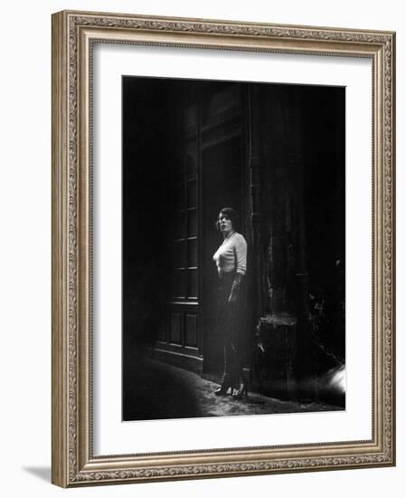 Atmospheric of Parisienne Prostitute Standing Near Doorway on Street-Alfred Eisenstaedt-Framed Photographic Print