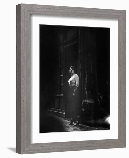 Atmospheric of Parisienne Prostitute Standing Near Doorway on Street-Alfred Eisenstaedt-Framed Photographic Print