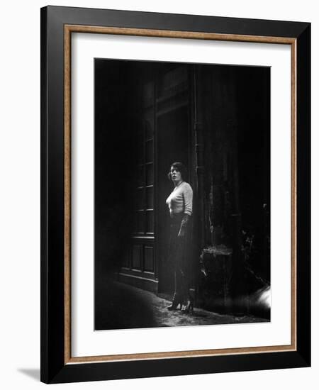 Atmospheric of Parisienne Prostitute Standing Near Doorway on Street-Alfred Eisenstaedt-Framed Photographic Print