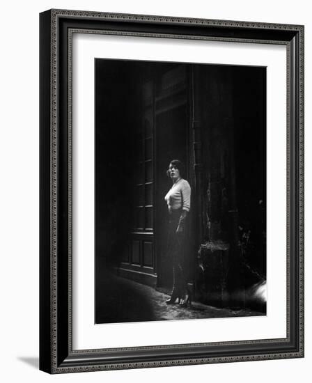 Atmospheric of Parisienne Prostitute Standing Near Doorway on Street-Alfred Eisenstaedt-Framed Photographic Print