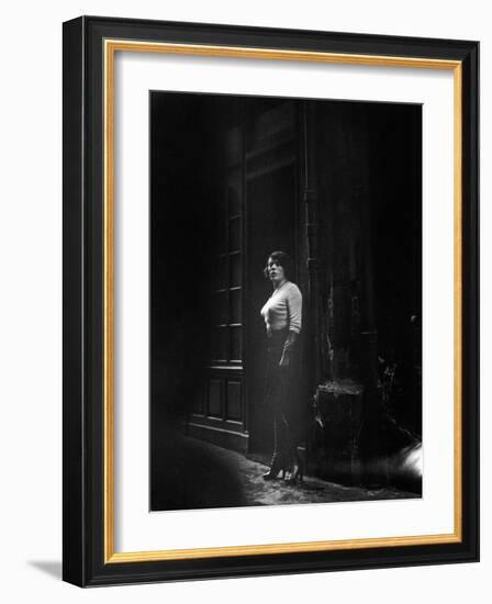 Atmospheric of Parisienne Prostitute Standing Near Doorway on Street-Alfred Eisenstaedt-Framed Photographic Print