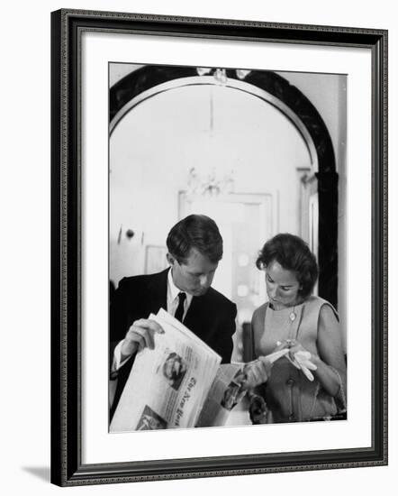 Attorney General Robert Kennedy and Wife Looking at Copy of the New York Times-George Silk-Framed Premium Photographic Print