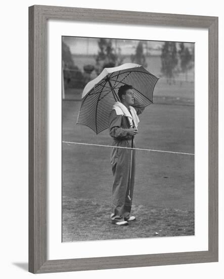 Australian Golfer Peter Thompson, Standing under Oversized Umbrella During the Los Angeles Open-Allan Grant-Framed Premium Photographic Print