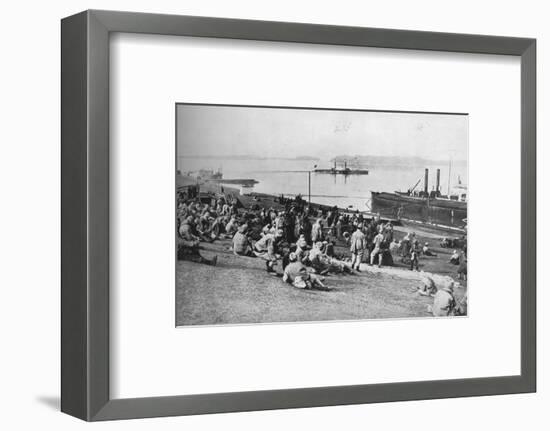 ''Austrian prisoners taken by Serbians resting at mid-day on the banks of the Danube', 1915-Unknown-Framed Photographic Print