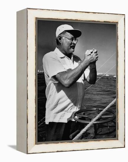 Author Ernest Hemingway at Wheel of Fishing Boat During Fishing Tournament-Alfred Eisenstaedt-Framed Premier Image Canvas