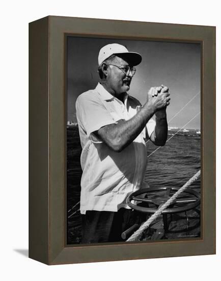 Author Ernest Hemingway at Wheel of Fishing Boat During Fishing Tournament-Alfred Eisenstaedt-Framed Premier Image Canvas