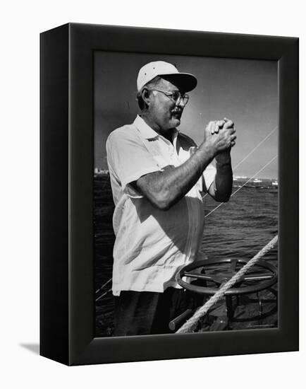 Author Ernest Hemingway at Wheel of Fishing Boat During Fishing Tournament-Alfred Eisenstaedt-Framed Premier Image Canvas