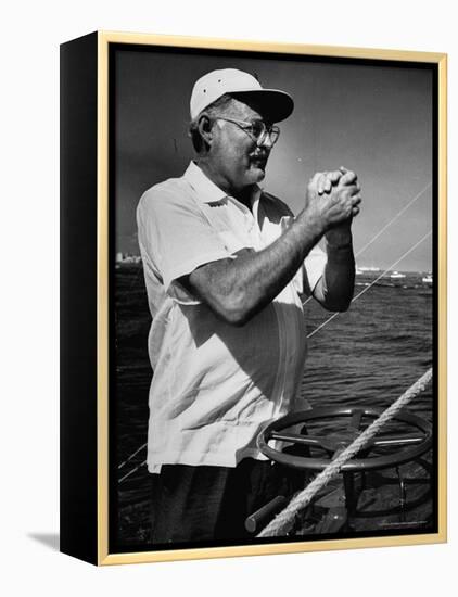 Author Ernest Hemingway at Wheel of Fishing Boat During Fishing Tournament-Alfred Eisenstaedt-Framed Premier Image Canvas