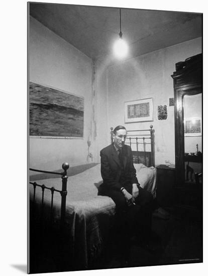 Author William Burroughs, an Ex Dope Addict, Relaxing on a Shabby Bed in a "Beat Hotel"-Loomis Dean-Mounted Premium Photographic Print