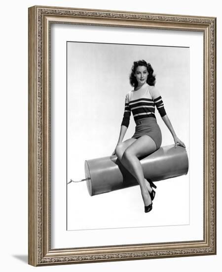 Ava Gardner seated on Giant firecracker, c. 1945 (b/w photo)-null-Framed Photo