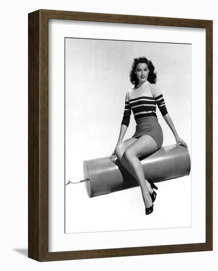 Ava Gardner seated on Giant firecracker, c. 1945 (b/w photo)-null-Framed Photo