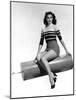 Ava Gardner seated on Giant firecracker, c. 1945 (b/w photo)-null-Mounted Photo