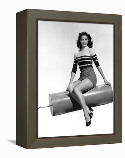 Ava Gardner seated on Giant firecracker, c. 1945 (b/w photo)-null-Framed Stretched Canvas