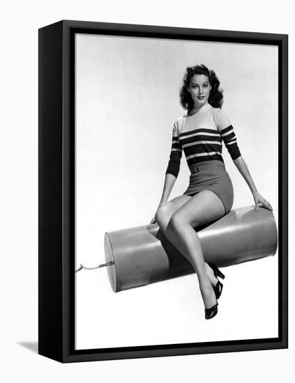 Ava Gardner seated on Giant firecracker, c. 1945 (b/w photo)-null-Framed Stretched Canvas