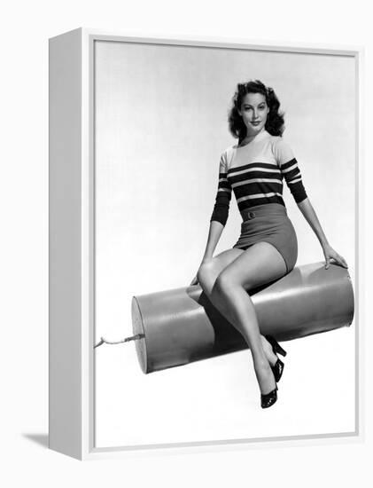 Ava Gardner seated on Giant firecracker, c. 1945 (b/w photo)-null-Framed Stretched Canvas