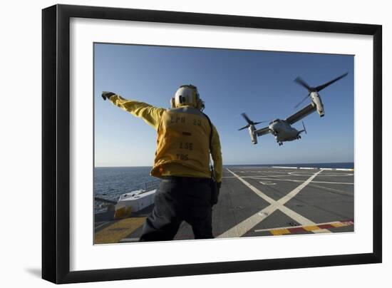 Aviation Boatswain's Mate Directs an MV-22 Osprey as it Launches from the Flight Deck-null-Framed Photographic Print