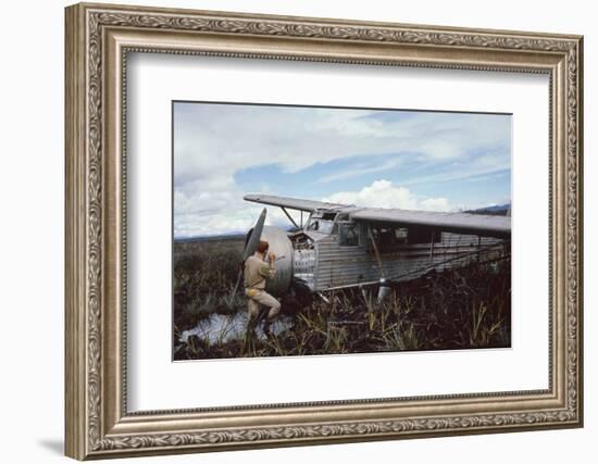 Aviator Roland Angel Repaints His Father's Flamingo Monoplane, Auyantepui, Venezuela, 1965-Carl Mydans-Framed Photographic Print