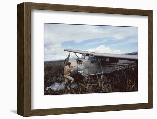 Aviator Roland Angel Repaints His Father's Flamingo Monoplane, Auyantepui, Venezuela, 1965-Carl Mydans-Framed Photographic Print