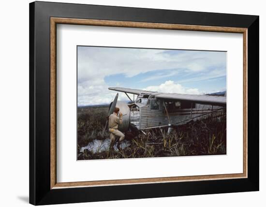 Aviator Roland Angel Repaints His Father's Flamingo Monoplane, Auyantepui, Venezuela, 1965-Carl Mydans-Framed Photographic Print