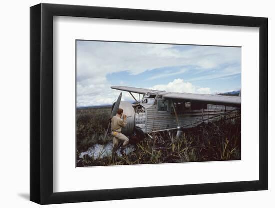 Aviator Roland Angel Repaints His Father's Flamingo Monoplane, Auyantepui, Venezuela, 1965-Carl Mydans-Framed Photographic Print