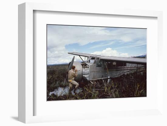 Aviator Roland Angel Repaints His Father's Flamingo Monoplane, Auyantepui, Venezuela, 1965-Carl Mydans-Framed Photographic Print