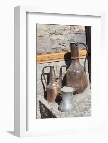 Azerbaijan, Lahic. A copper kettle and jug sitting outside a residence.-Alida Latham-Framed Photographic Print