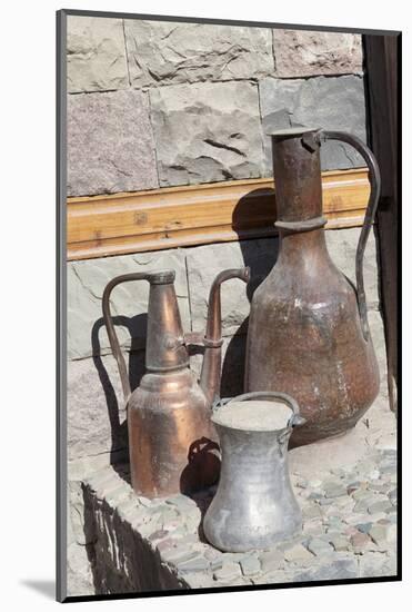 Azerbaijan, Lahic. A copper kettle and jug sitting outside a residence.-Alida Latham-Mounted Photographic Print